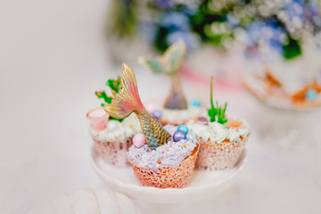 Candy bar, maritime cookies and pearl macarons. Catering buffet style.	