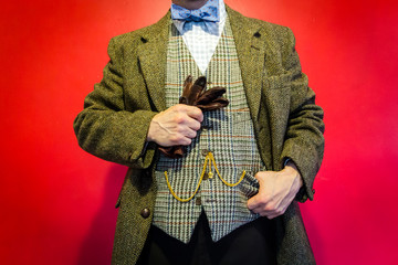 Portrait of Fancy Man in Tweed Jacket Holding Gloves and Standing Confidently. Retro Style of Country Gentleman. Wealth and Power. English Gentleman.