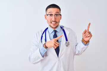 Young doctor man wearing stethoscope over isolated background Pointing aside worried and nervous with both hands, concerned and surprised expression