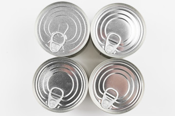 Group of silver canned food on white background.