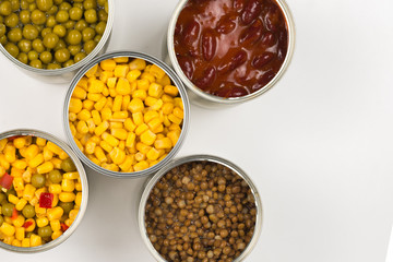 Canned food on white background. Green pea, beans, corn, lentils.