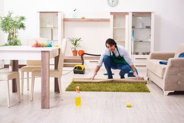 Fototapeta na wymiar Young businessman cleaning the house