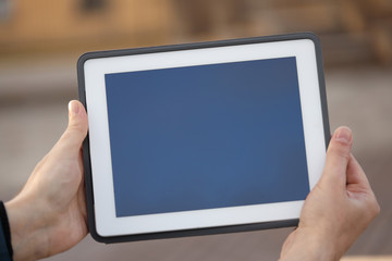 tablet in hands, on a blank screen place for text