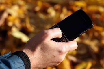 mobile phone in hand sending message