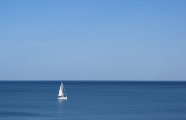 Fototapeta premium Sailboat lost in the sea on a sunny day
