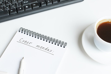Text cyber monday written on opened notebook, sketchbook on white background. Flat lay, top view, copy space.