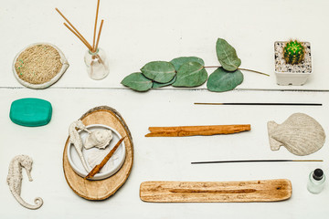 Aerial photography of aromatherapy elements on white wooden background