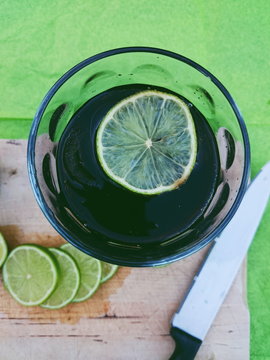 Overhead view of a drink with fresh lime