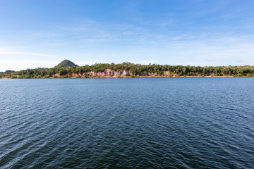 Fototapeta na wymiar Panoramic view of Rio Tapajos in sunny summer day with rainforest, hills and beaches in Alter do Chao village, Pará, Brazil. Travel, amazon, vacation, adventure, environment and conservation concept.