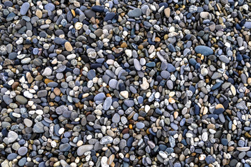 Background of smooth beautiful stones on the beach after a storm for Holidays,