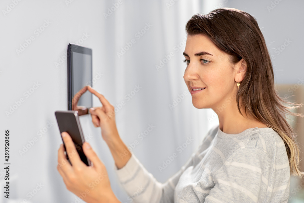 Poster automation, internet of things and technology concept - woman using tablet pc computer and smartphon
