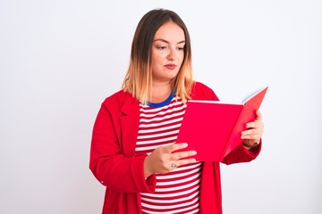 Fototapeta premium Young beautiful woman reading book standing over isolated white background with a confident expression on smart face thinking serious