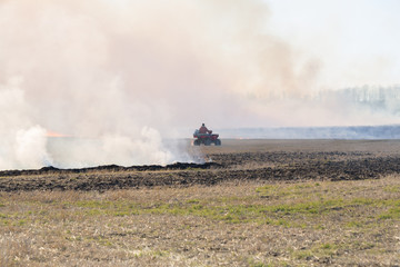 Fototapeta na wymiar farmer burning field of straw