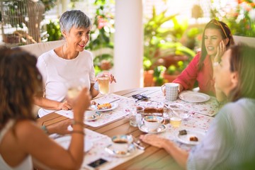 Young beautiful girl smiling happy and confident sitting dinking cup of coffee at terrace