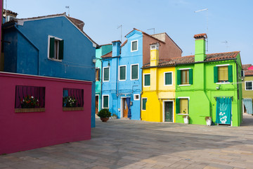 Colorful houses in Burano island. Canal view with boats. Travel photo. Venice. Italy. Europe.