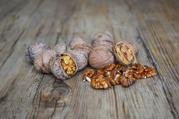 Walnuts closeup on a wooden background, selective focus