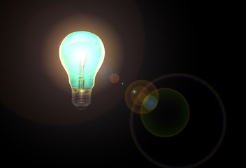 lit incandescent light bulb with lens flare on a black background