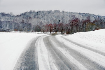 Fototapeta premium Beautiful winter landscape with snow-covered trees and road in Latvia.