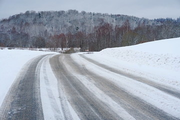 Obraz premium Beautiful winter landscape with snow-covered trees and road in Latvia.