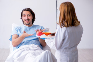 Male patient eating food in the hospital