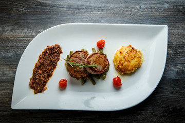 top view on tasty restaurant dish of roasted meat with mushroom sauce