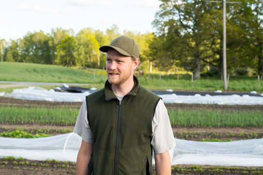 Portrait Of A Farmer Standing In His Garden