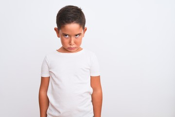 Beautiful kid boy wearing casual t-shirt standing over isolated white background skeptic and nervous, frowning upset because of problem. Negative person.