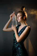 Naklejka premium Young woman with smoke and movie light in a dark room