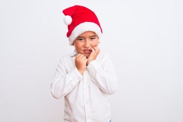 Beautiful kid boy wearing Christmas Santa hat standing over isolated white background touching mouth with hand with painful expression because of toothache or dental illness on teeth. Dentist concept.