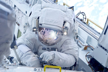 Astronaut at the space station is engaged in repairs. Elements of this image were furnished by NASA.