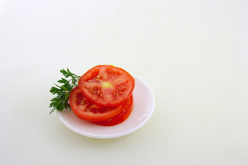 Sliced tomato with parsley on white background with space for texts (copy space)