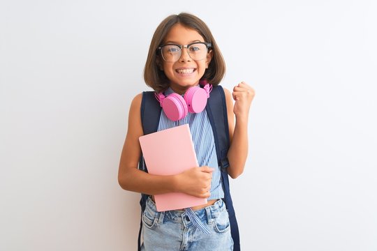 Student Child Girl Wearing Backpack Glasses Book Headphones Over Isolated White Background Screaming Proud And Celebrating Victory And Success Very Excited, Cheering Emotion