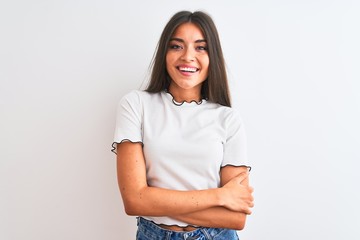 Young beautiful woman wearing casual t-shirt standing over isolated white background happy face smiling with crossed arms looking at the camera. Positive person.