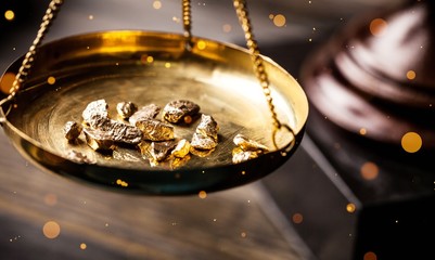 Small gold nuggets in an antique measuring