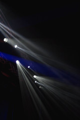 many spotlights shining above the stage