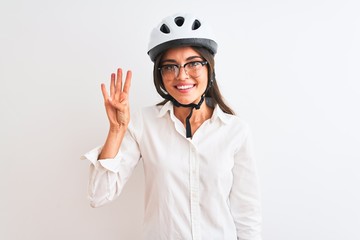 Beautiful businesswoman wearing glasses and bike helmet over isolated white background showing and pointing up with fingers number four while smiling confident and happy.
