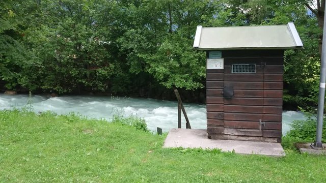 A wooden hut by the flowing river in Garmisch-Partenkirchen / Germany.