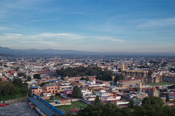 Panoramic view of the city, Popocatepetl volcano, San Gabriel Convent, the city is famous for its Great Pyramid, the largest archaeological site in the world at its base