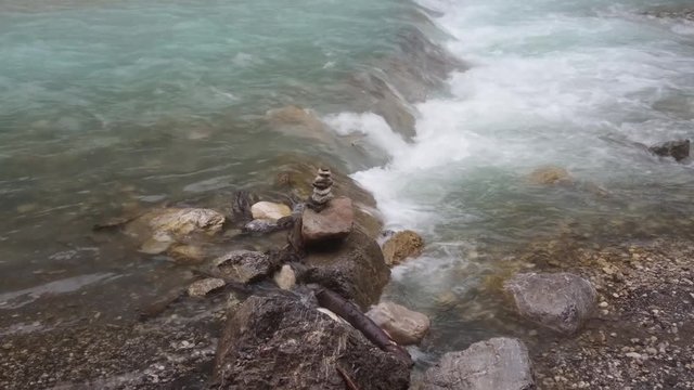 Man-made stone mound beside the flowing river in Garmisch-Partenkirchen / Germany.