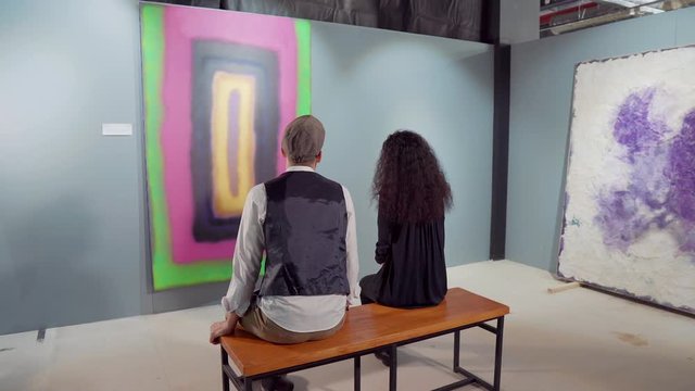 Art connoisseurs talking about the piece of modern art