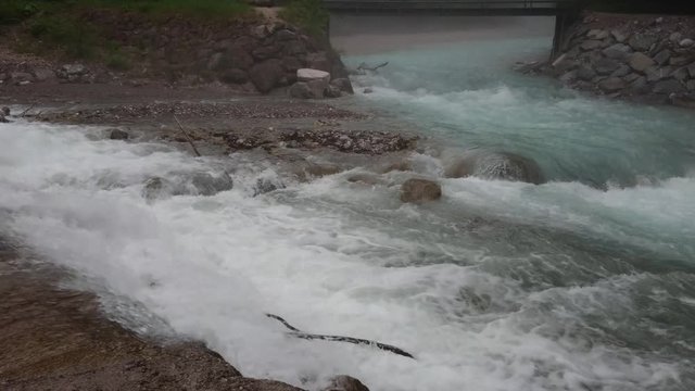 Flowing wild water beside the rocks near Partnach Gorge in Garmisch-Partenkirchen.