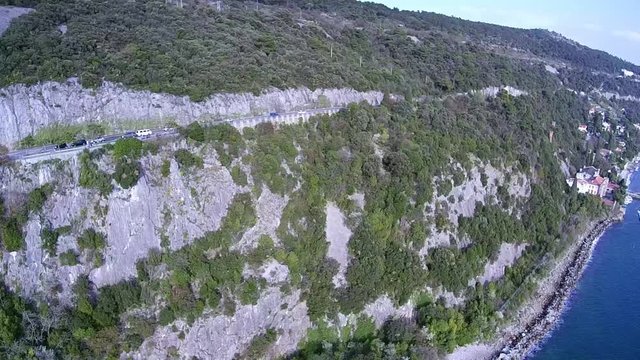 Aerial view of Coastal road. Drone flying along coast near Trieste Italy.