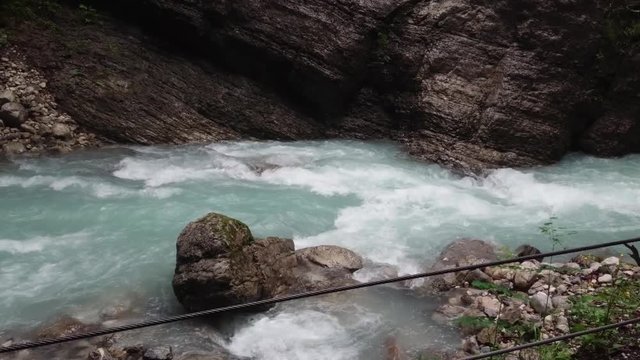 Inside the huge rocky Partnach Gorge flowing white water.