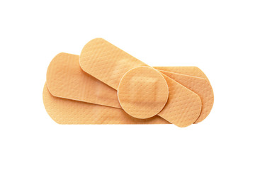 Adhesive bandages isolated on white background. Pile of beige medical plasters