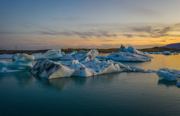 Fototapeta na wymiar Blue icebergs floating in the jokulsarlon lagoon in Iceland in the september 2019
