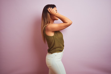 Young beautiful hispanic woman standing wearing green t-shirt