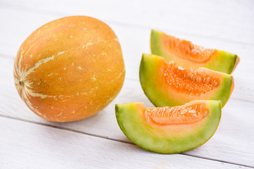 Muskmelon sliced cantaloupe thai tropical fruit asian on wood background - melon yellow