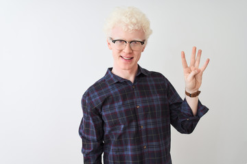 Young albino blond man wearing casual shirt and glasses over isolated white background showing and pointing up with fingers number four while smiling confident and happy.