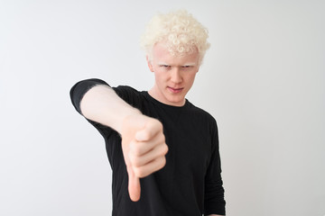 Young albino blond man wearing black t-shirt standing over isolated white background looking...