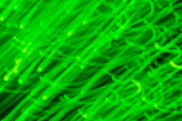 Futuristic blurred lights holiday monochrome background in bright green neon. Horizontal, soft focus
